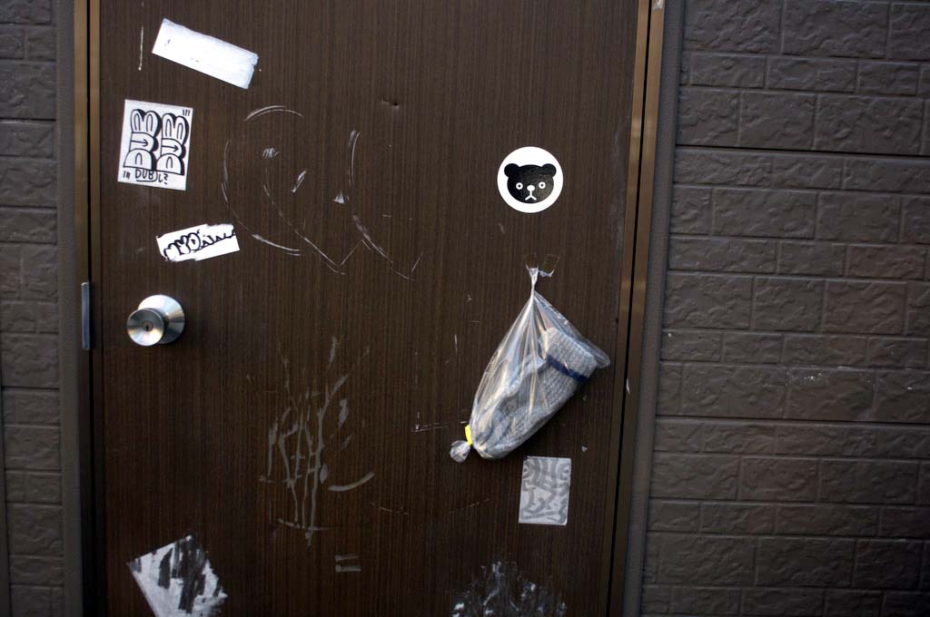 Tokyo: glove pinned to door
